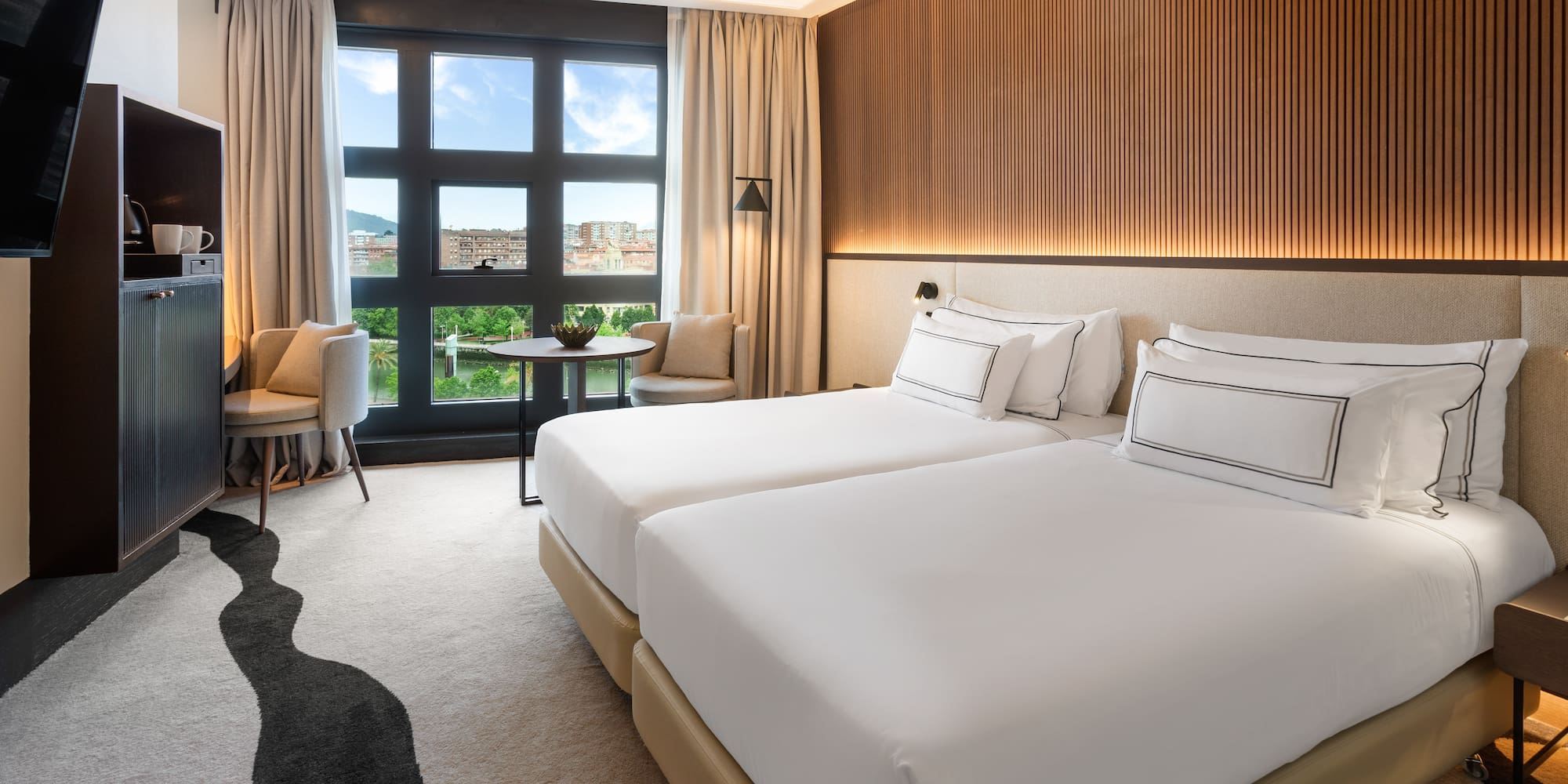 a hotel room with two beds and a table