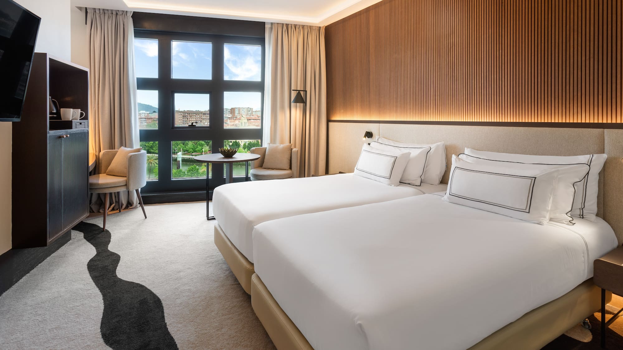 a hotel room with two beds and a table