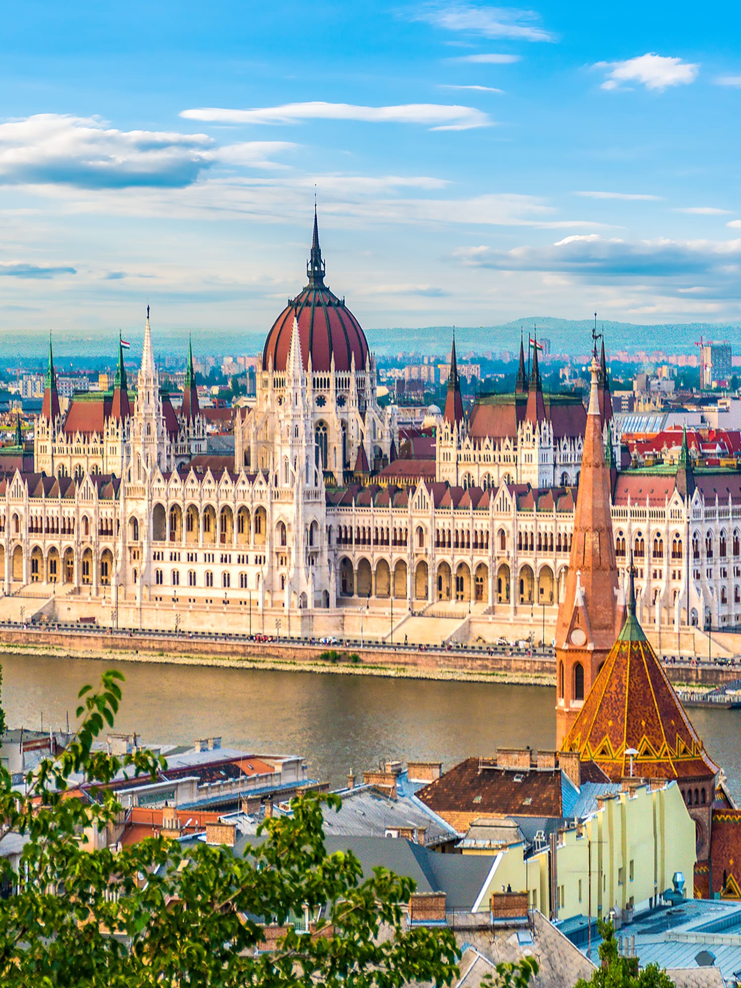 a large building with a river in the background