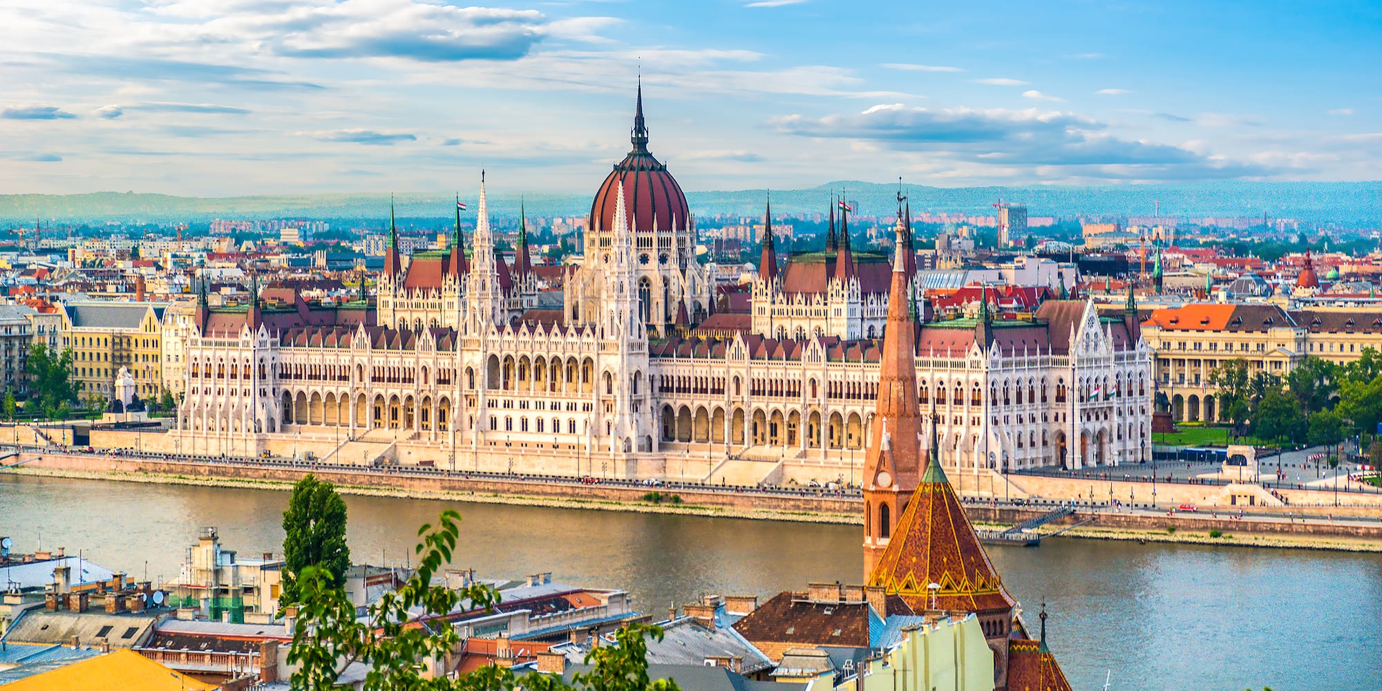 a large building with a river in the background