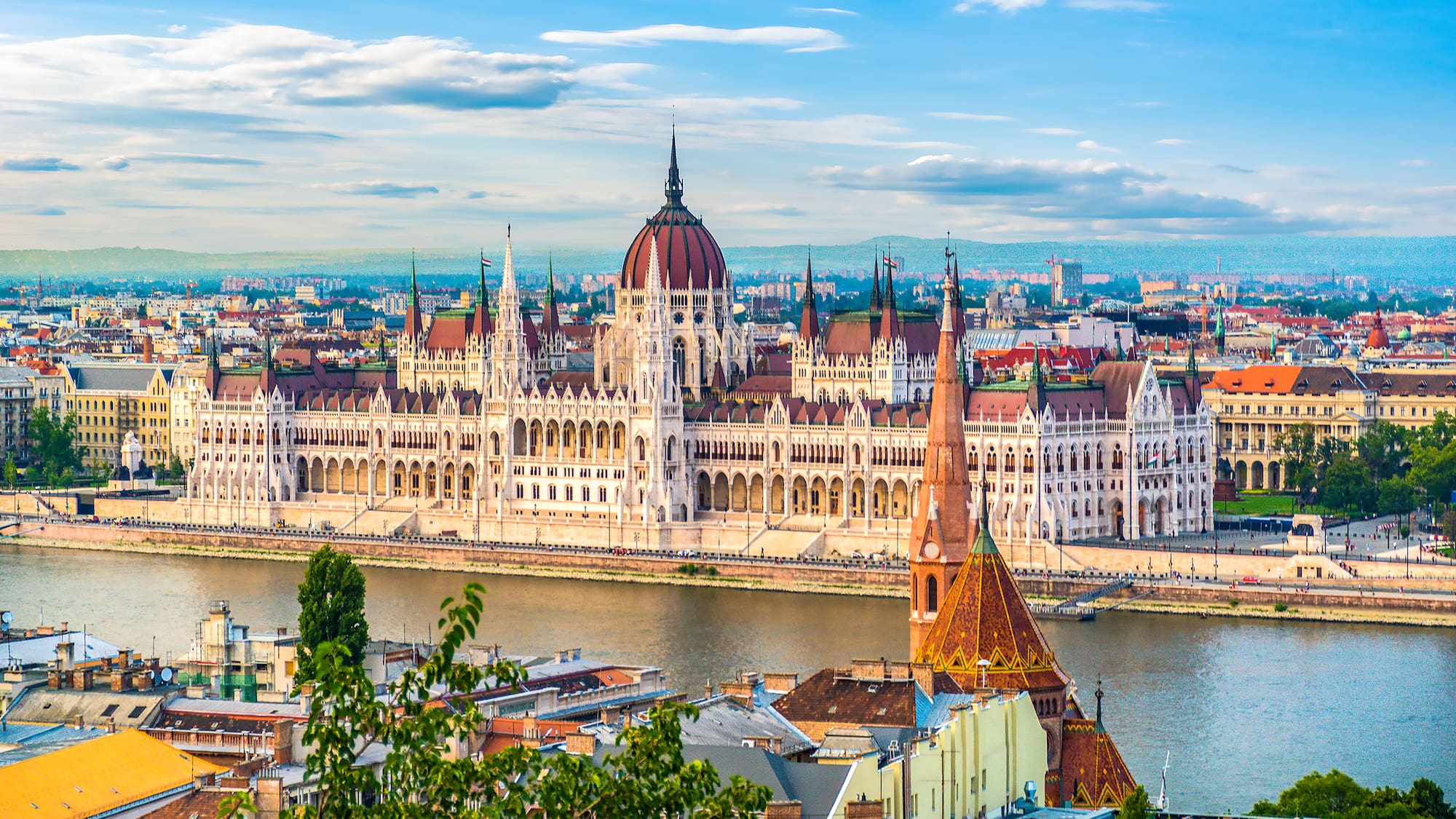 a large building with a river in the background