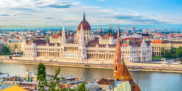 a large building with a river in the background