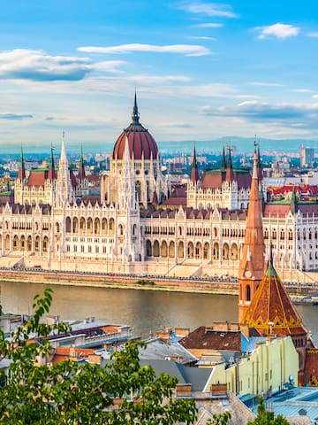 a large building with a river in the background