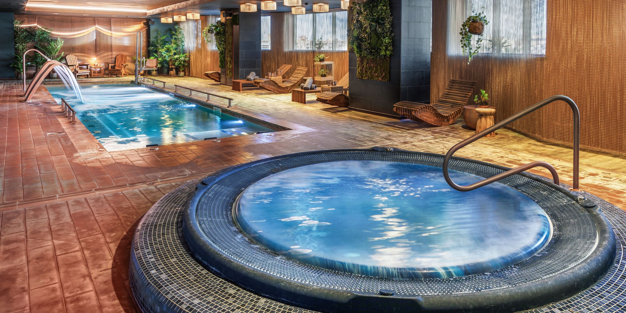 a indoor pool with a hot tub