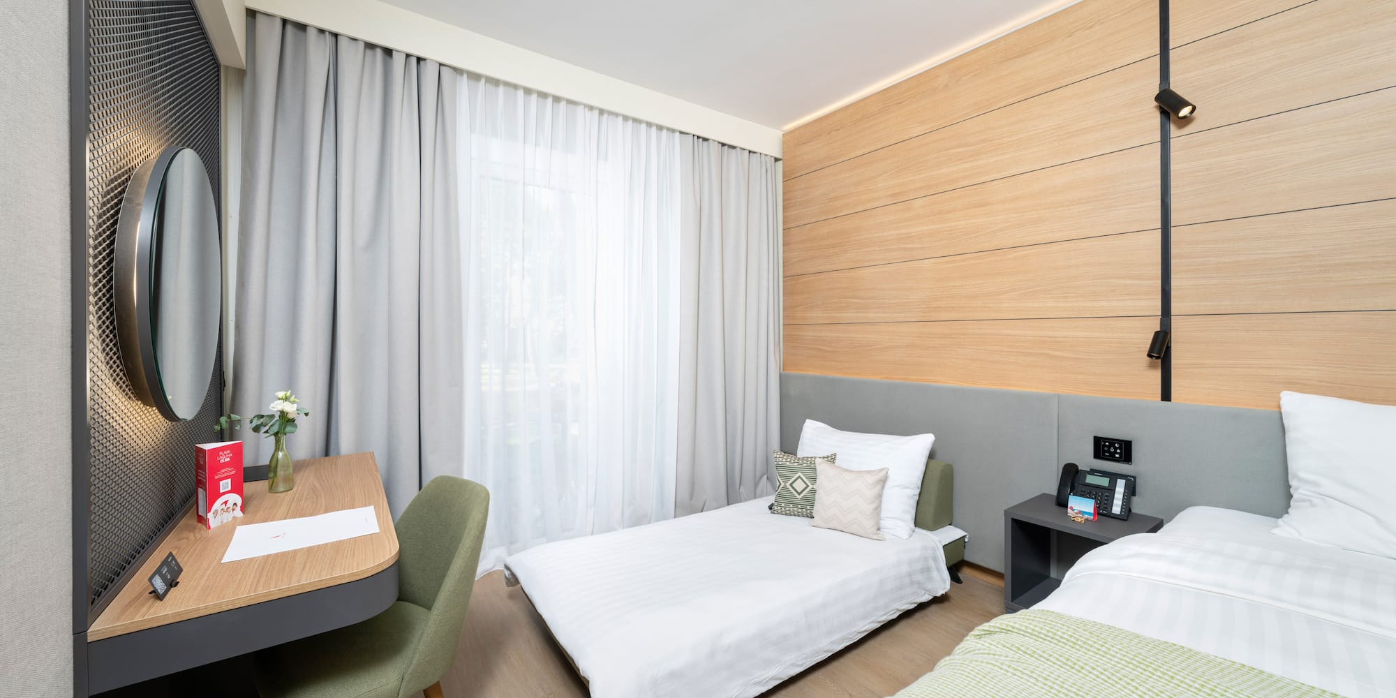 a room with two beds and a desk