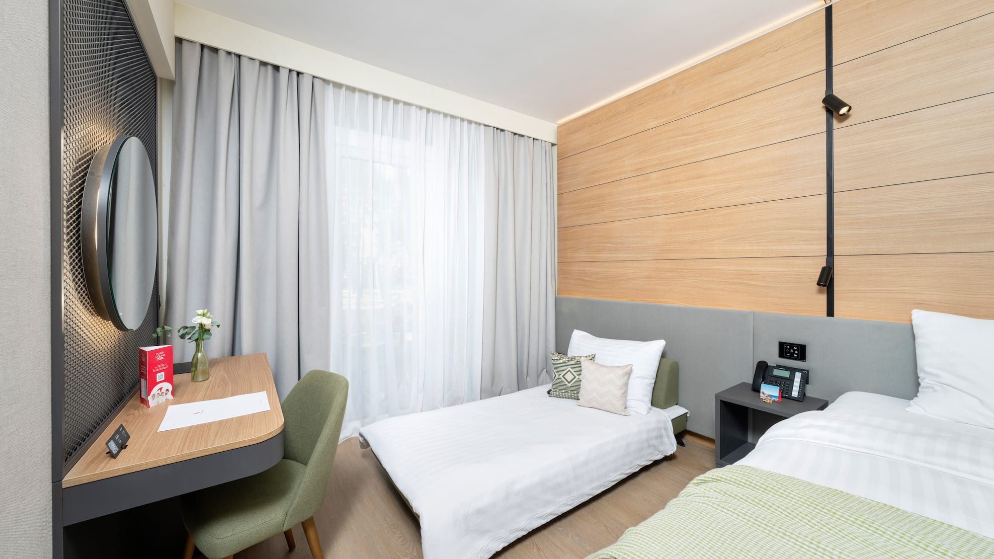 a room with two beds and a desk