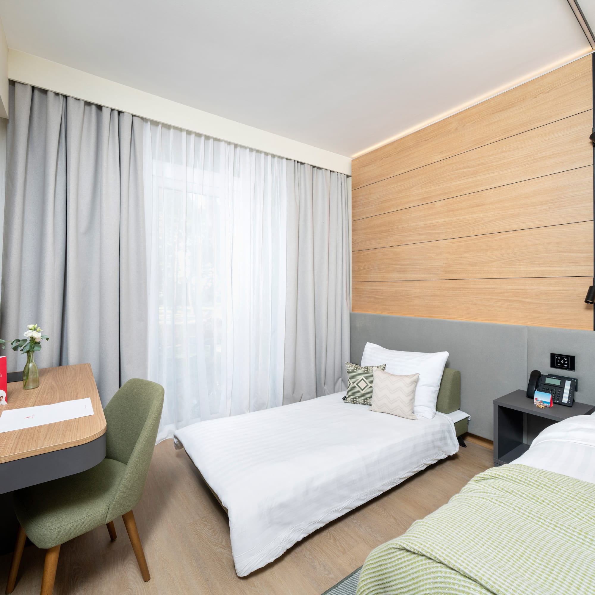 a room with two beds and a desk