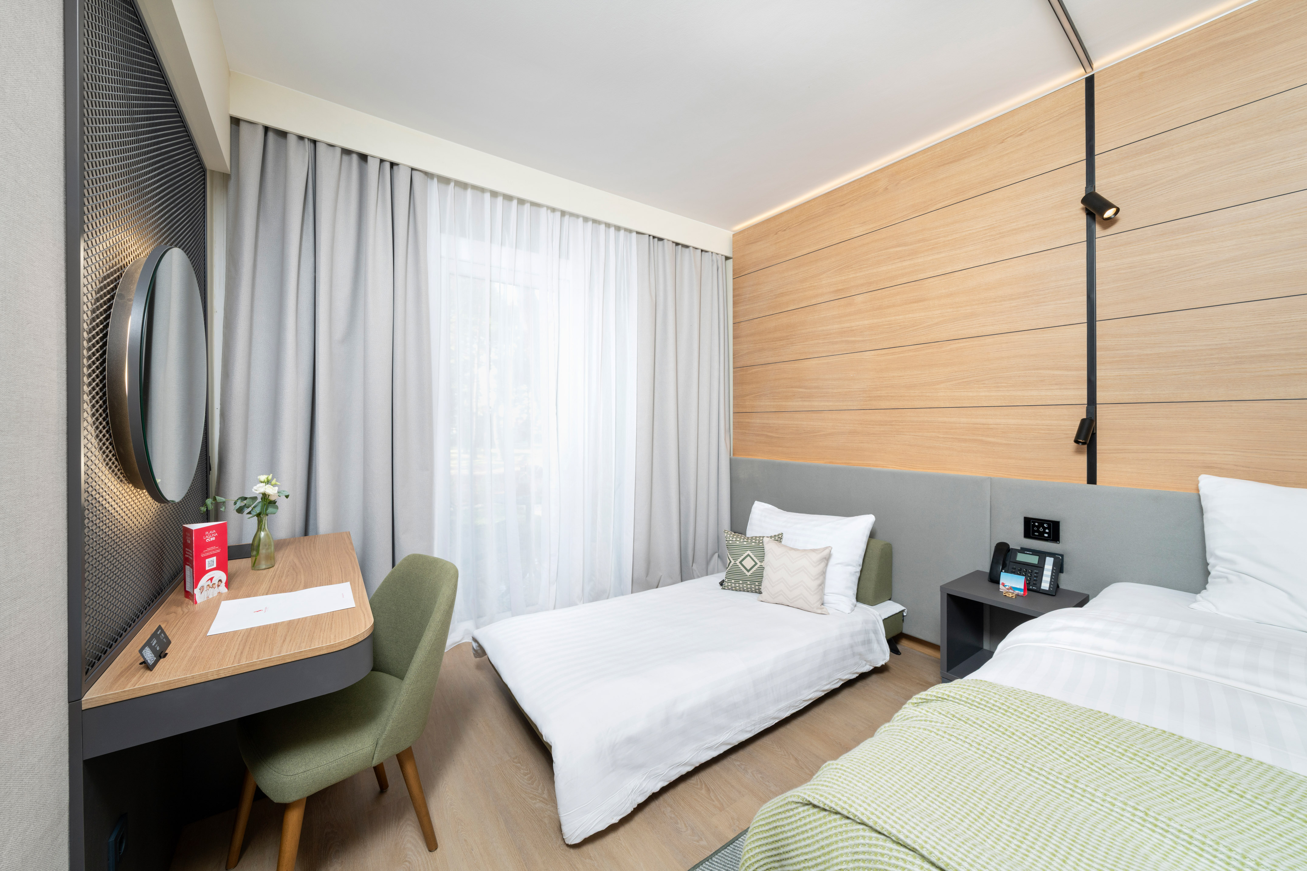 a room with two beds and a desk