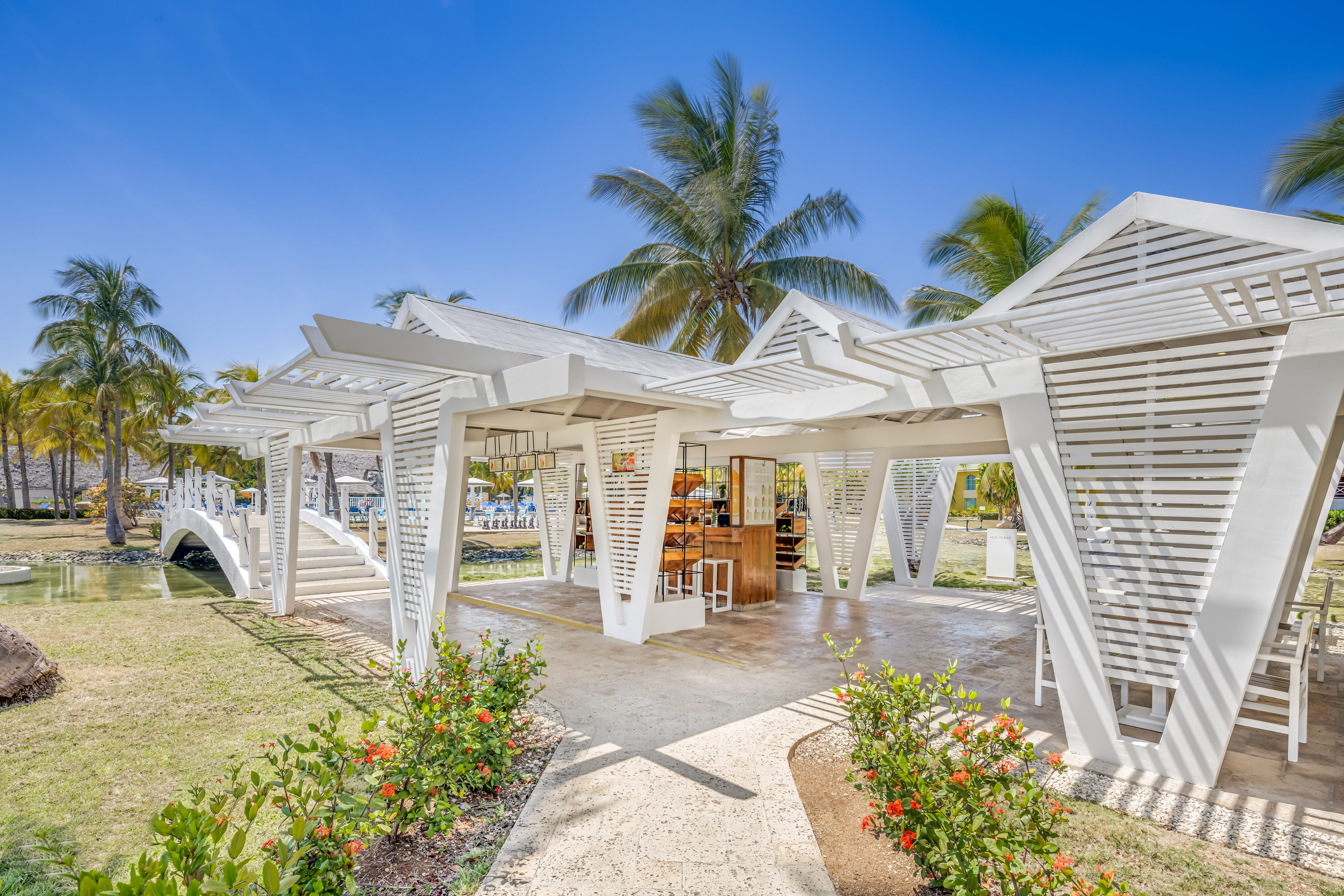 a white structure with a bar and chairs