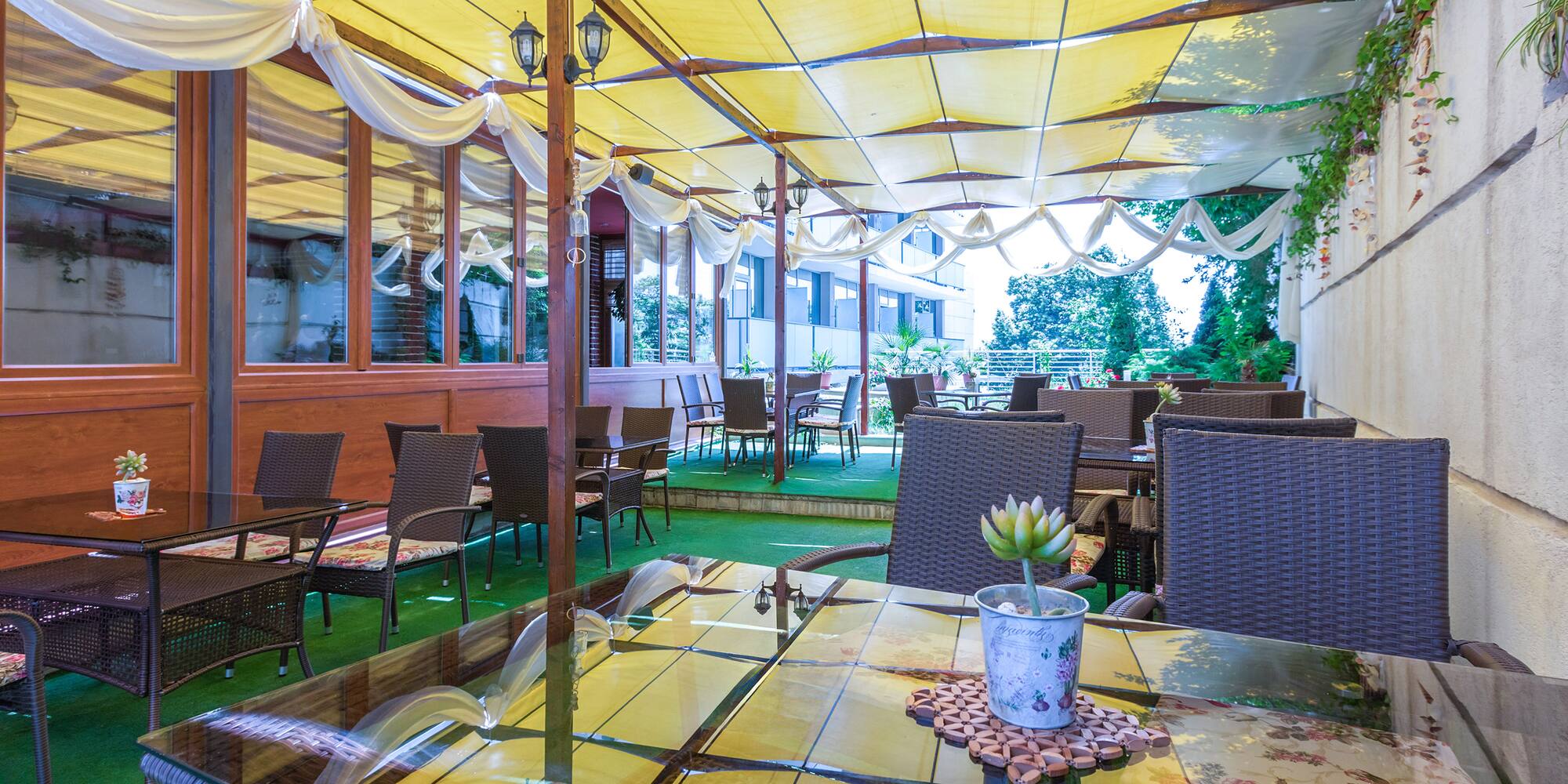 a patio with tables and chairs