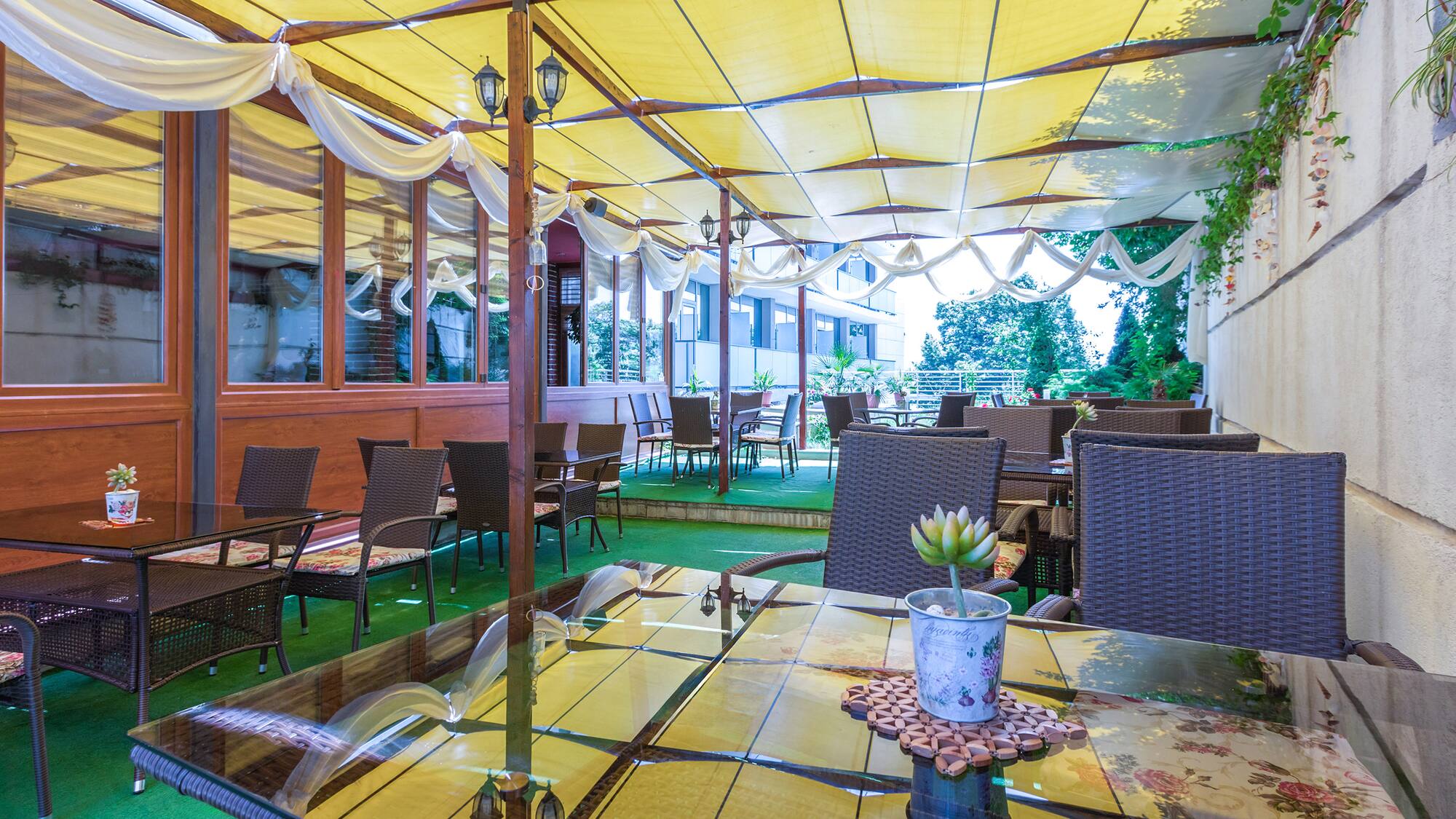 a patio with tables and chairs