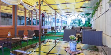 a patio with tables and chairs