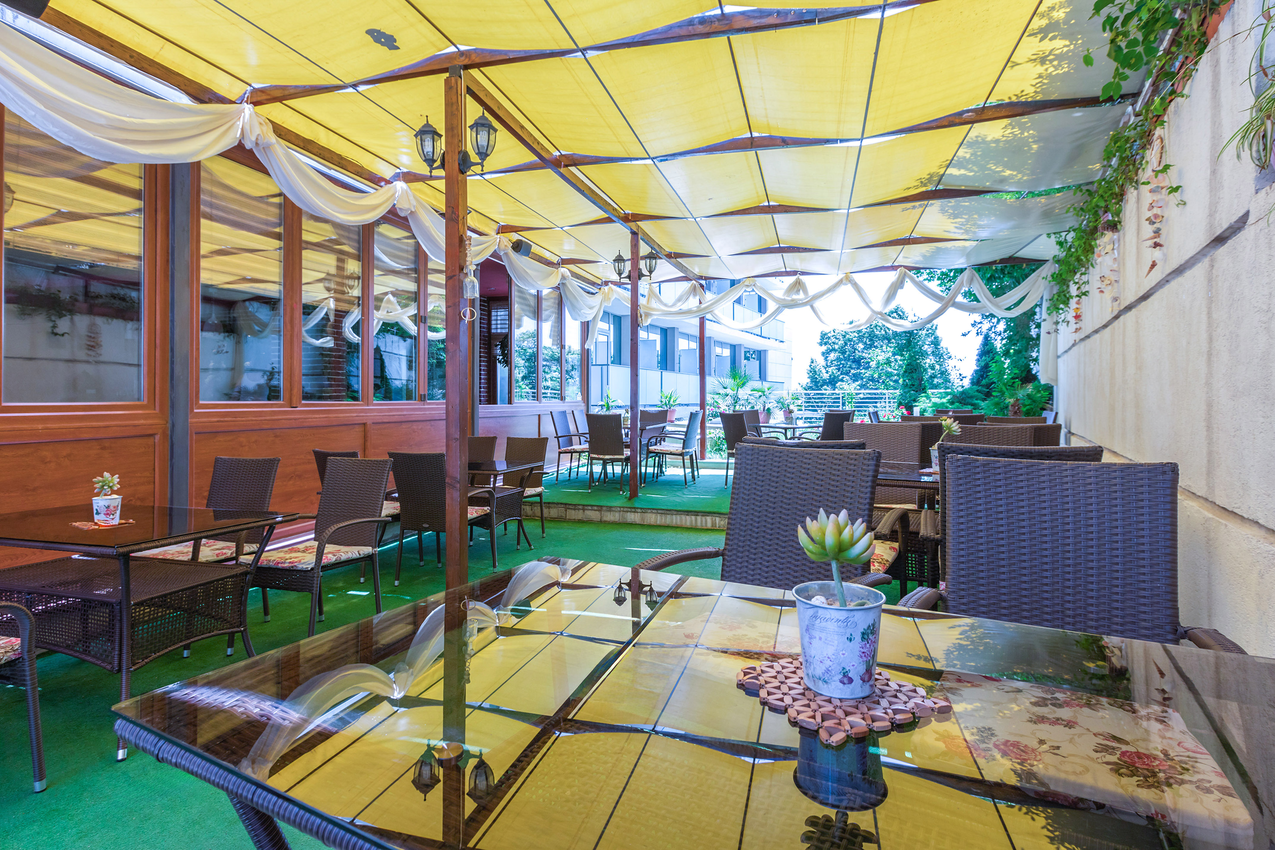 a patio with tables and chairs