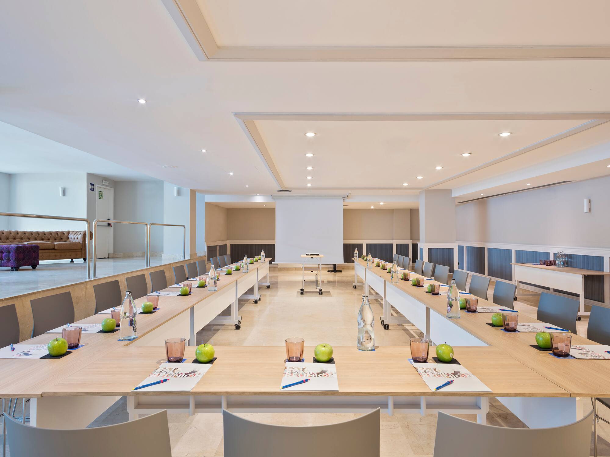 a room with long tables and chairs