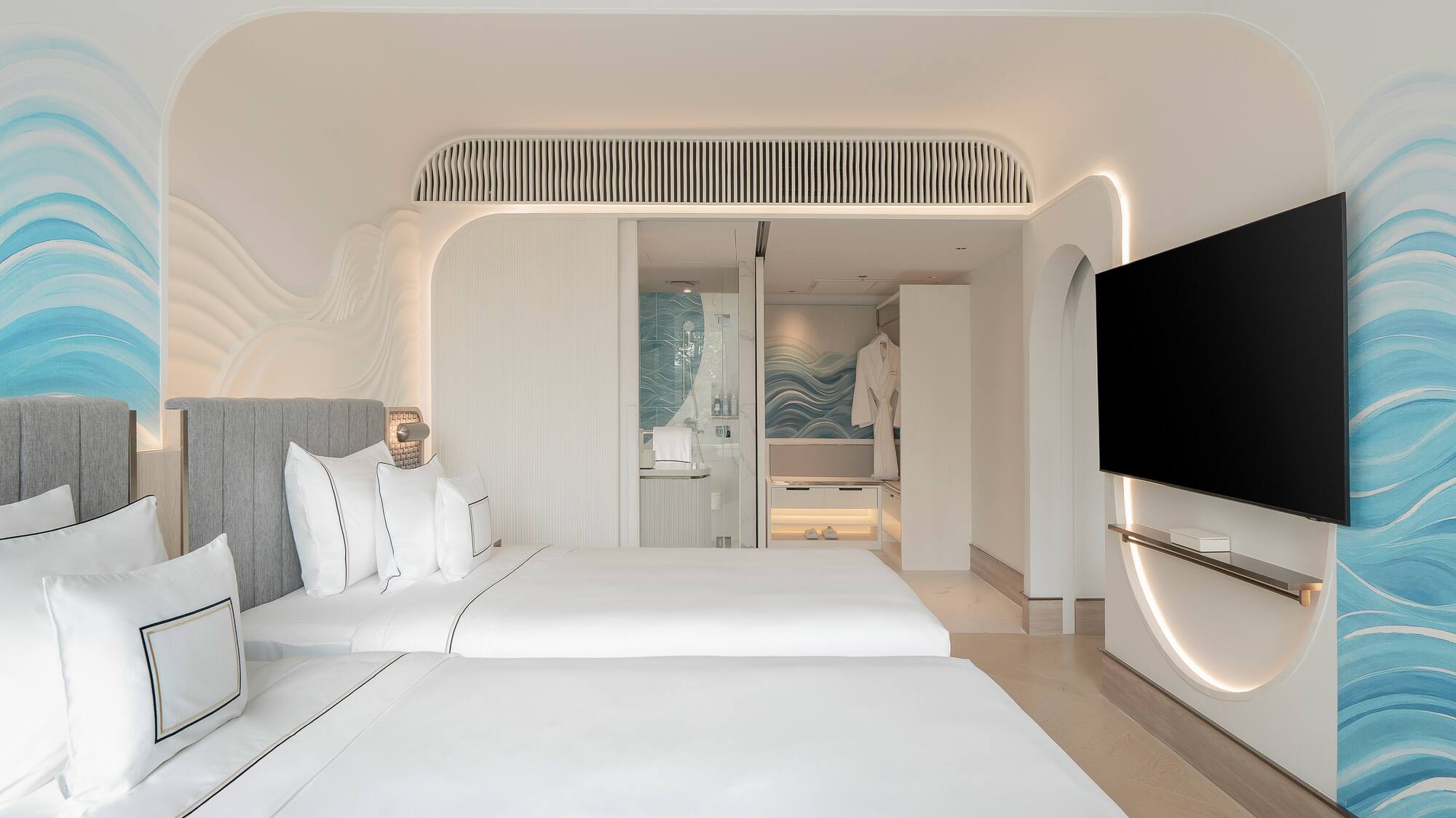 a room with two beds and a television