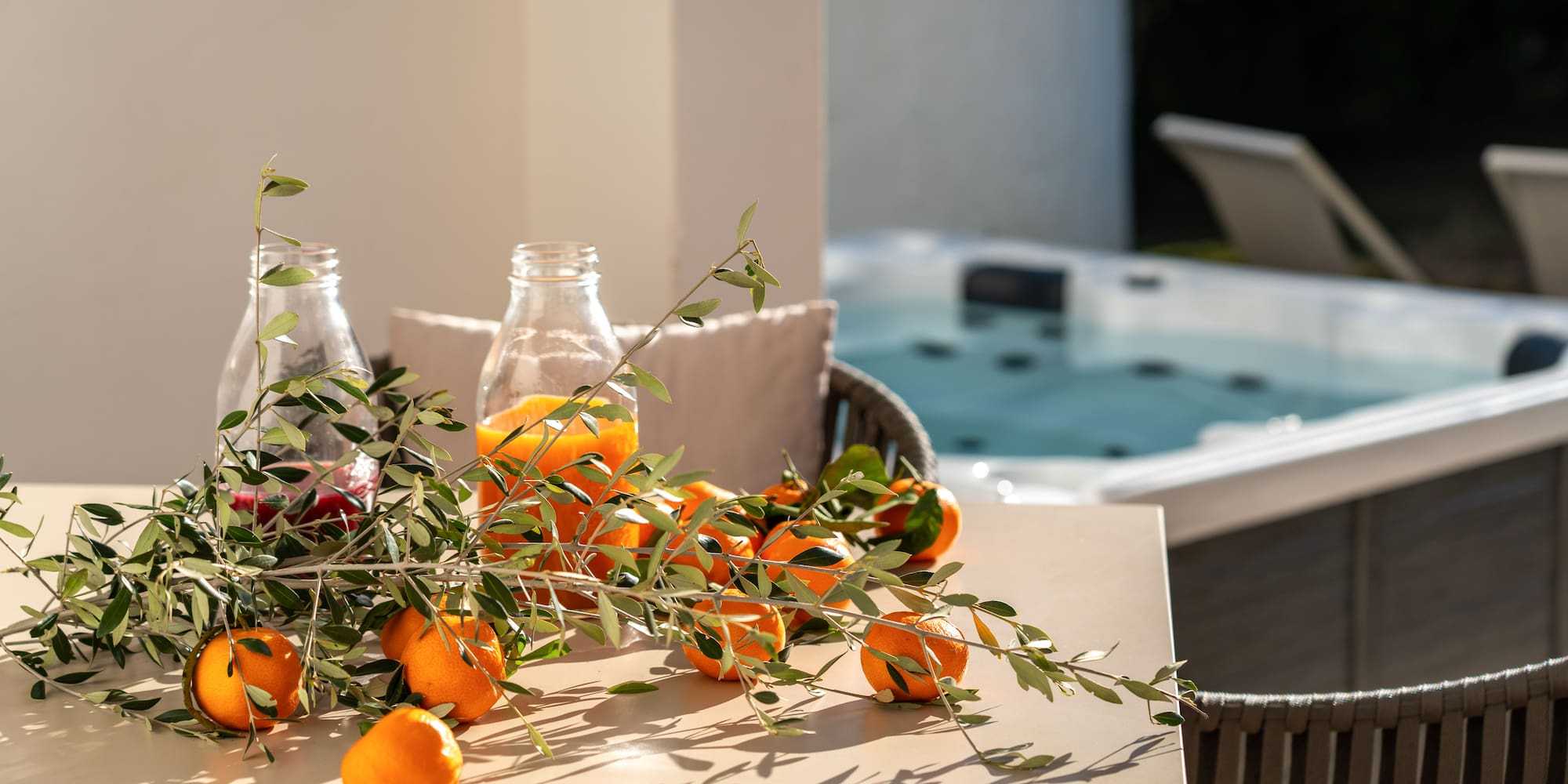 oranges on a table with a hot tub in the background