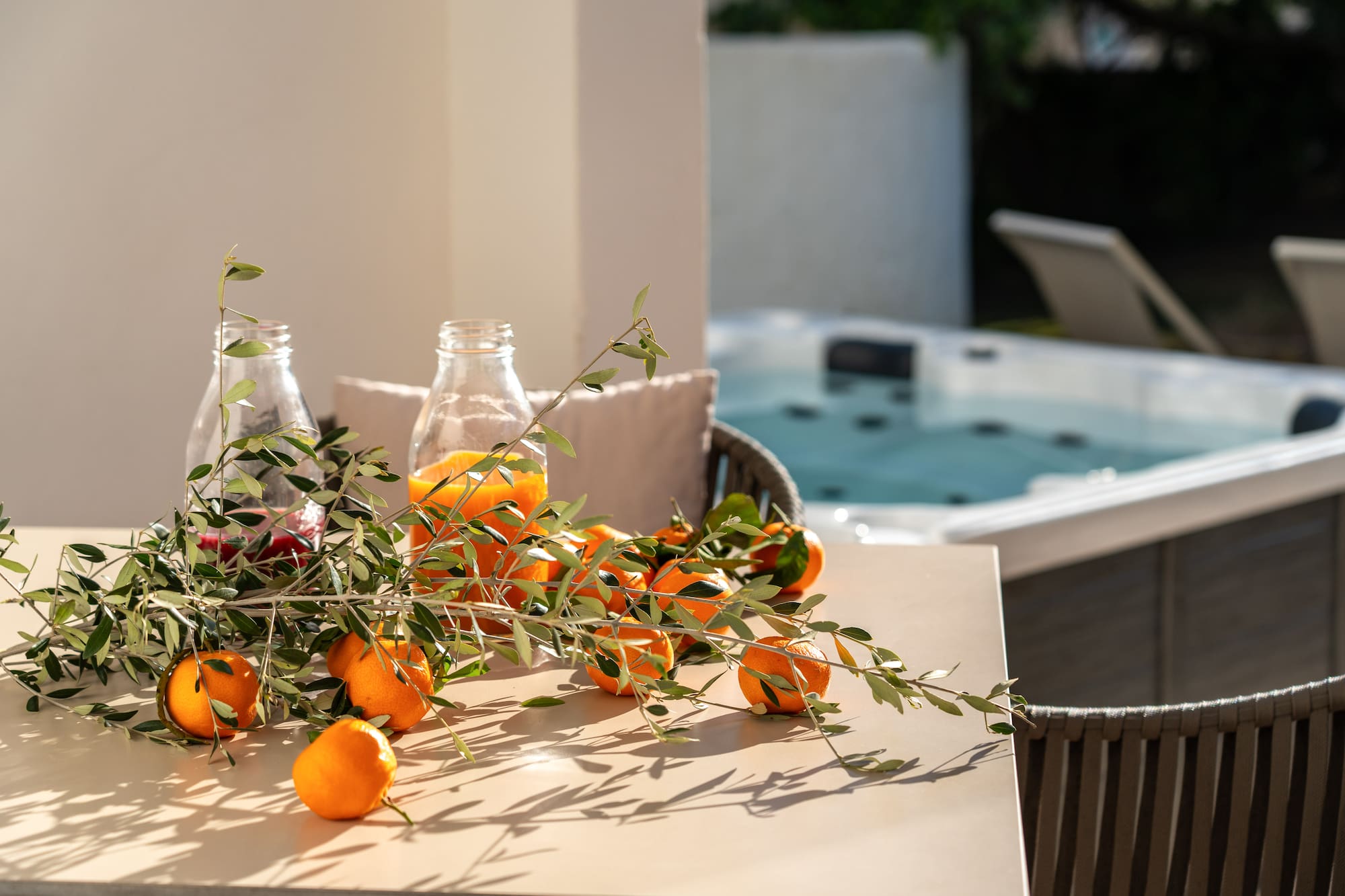oranges on a table with a hot tub in the background