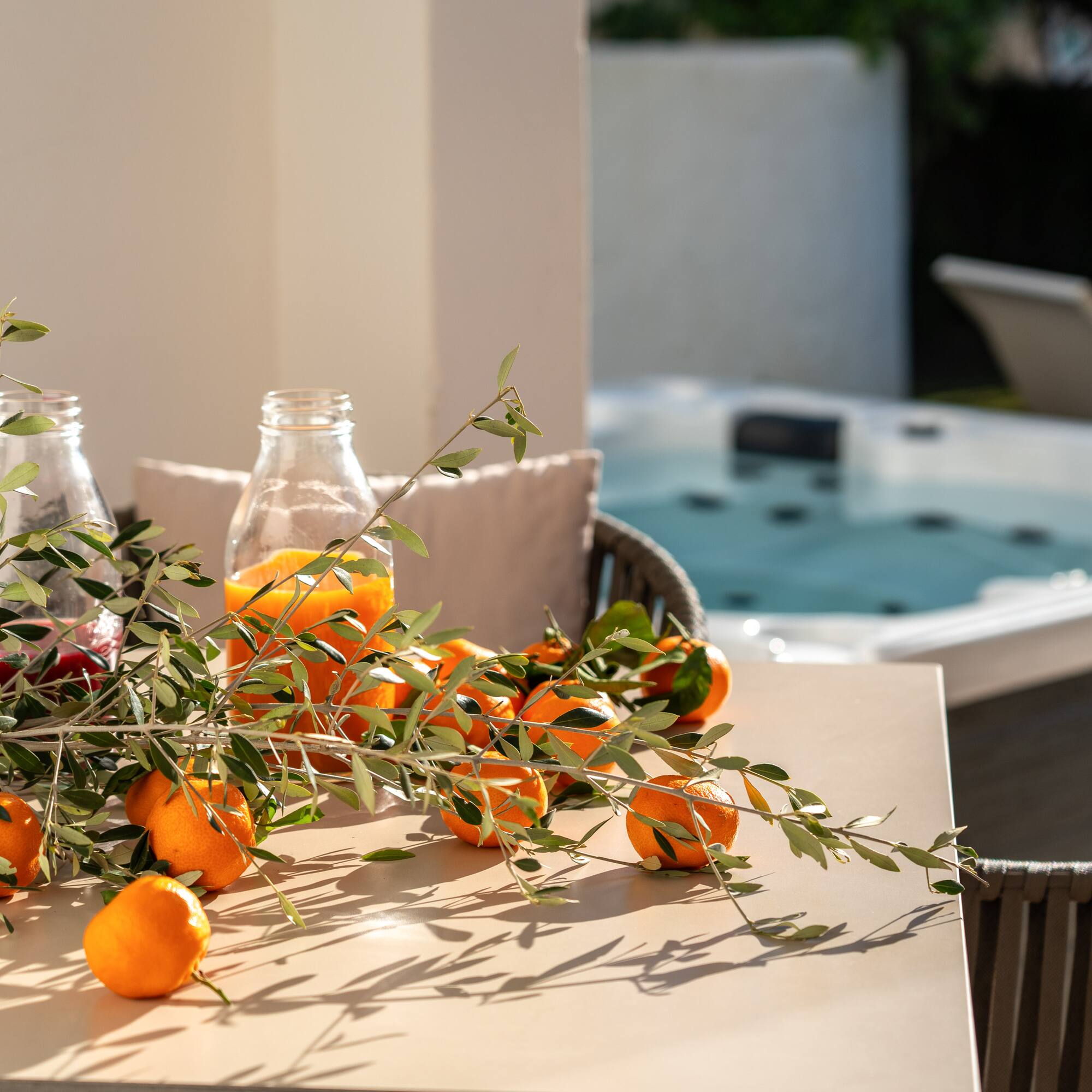 oranges on a table with a hot tub in the background