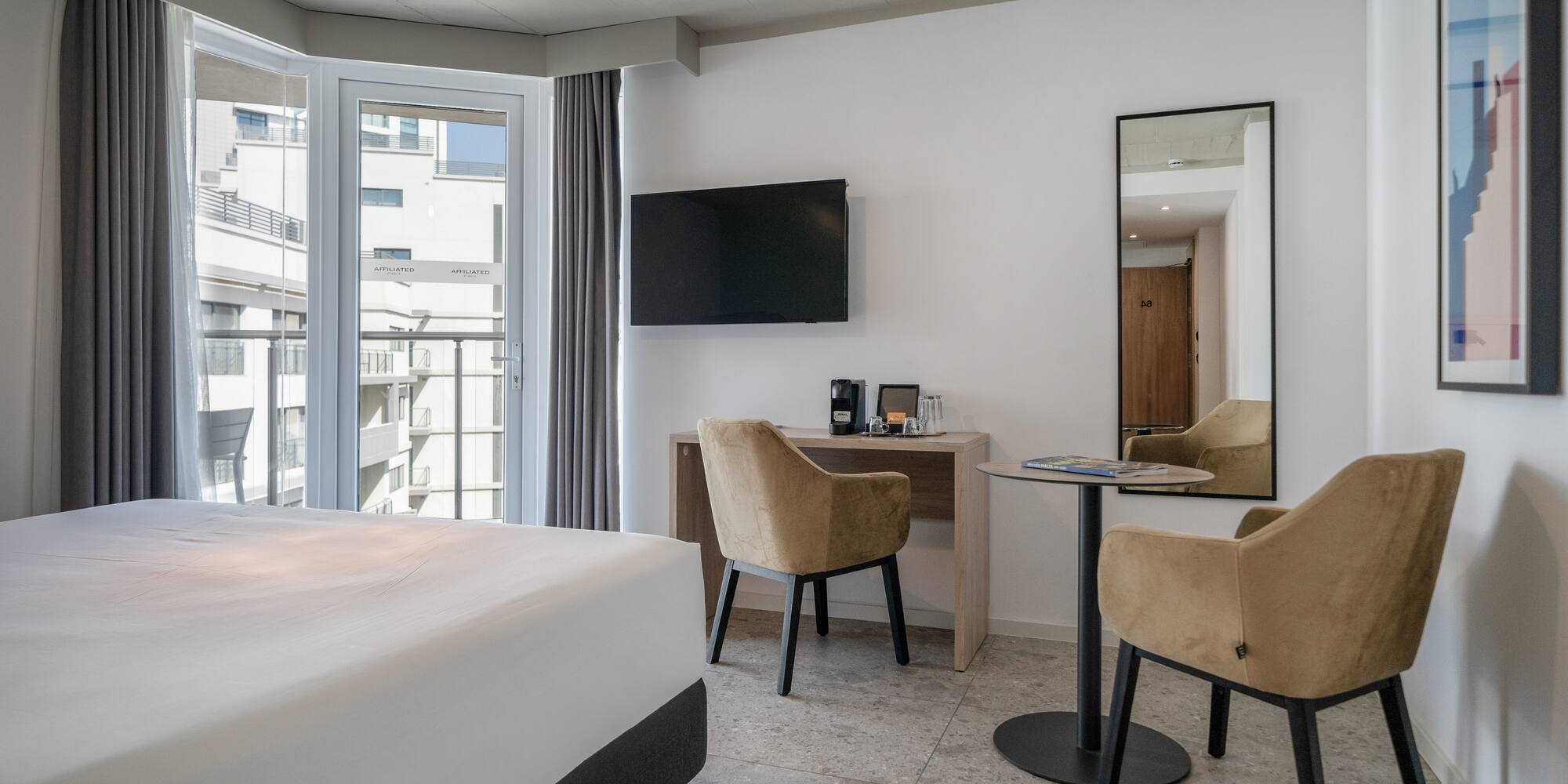 a room with a bed and a table and chairs