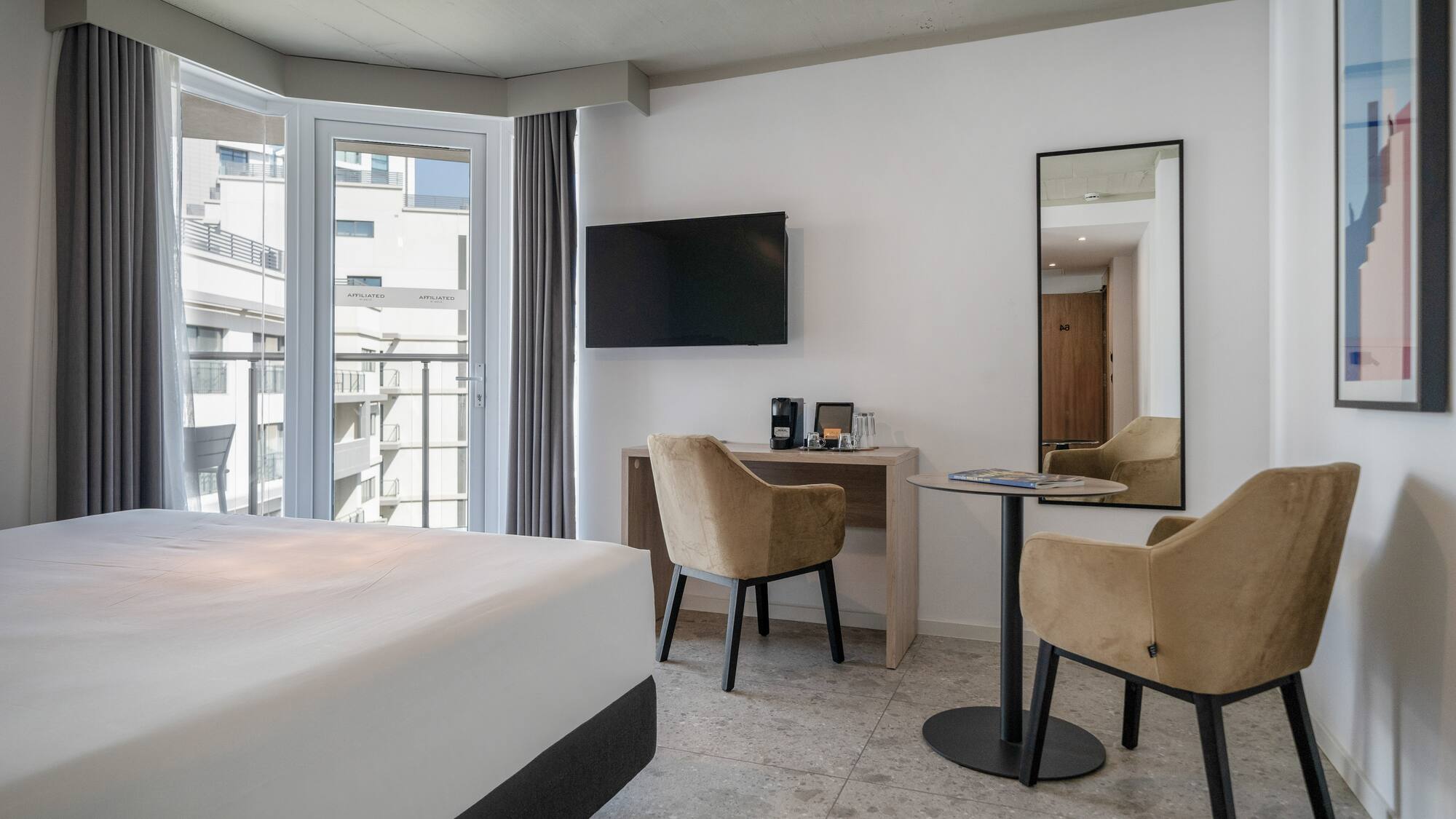 a room with a bed and a table and chairs