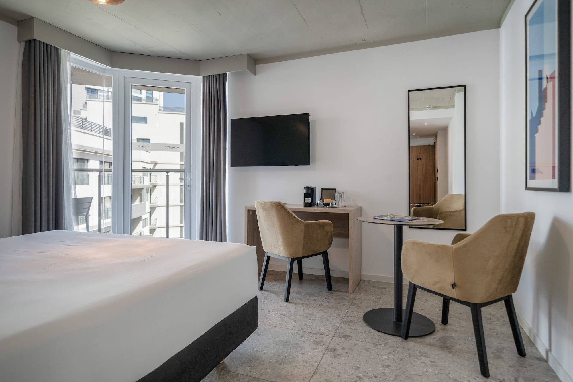 a room with a bed and a table and chairs