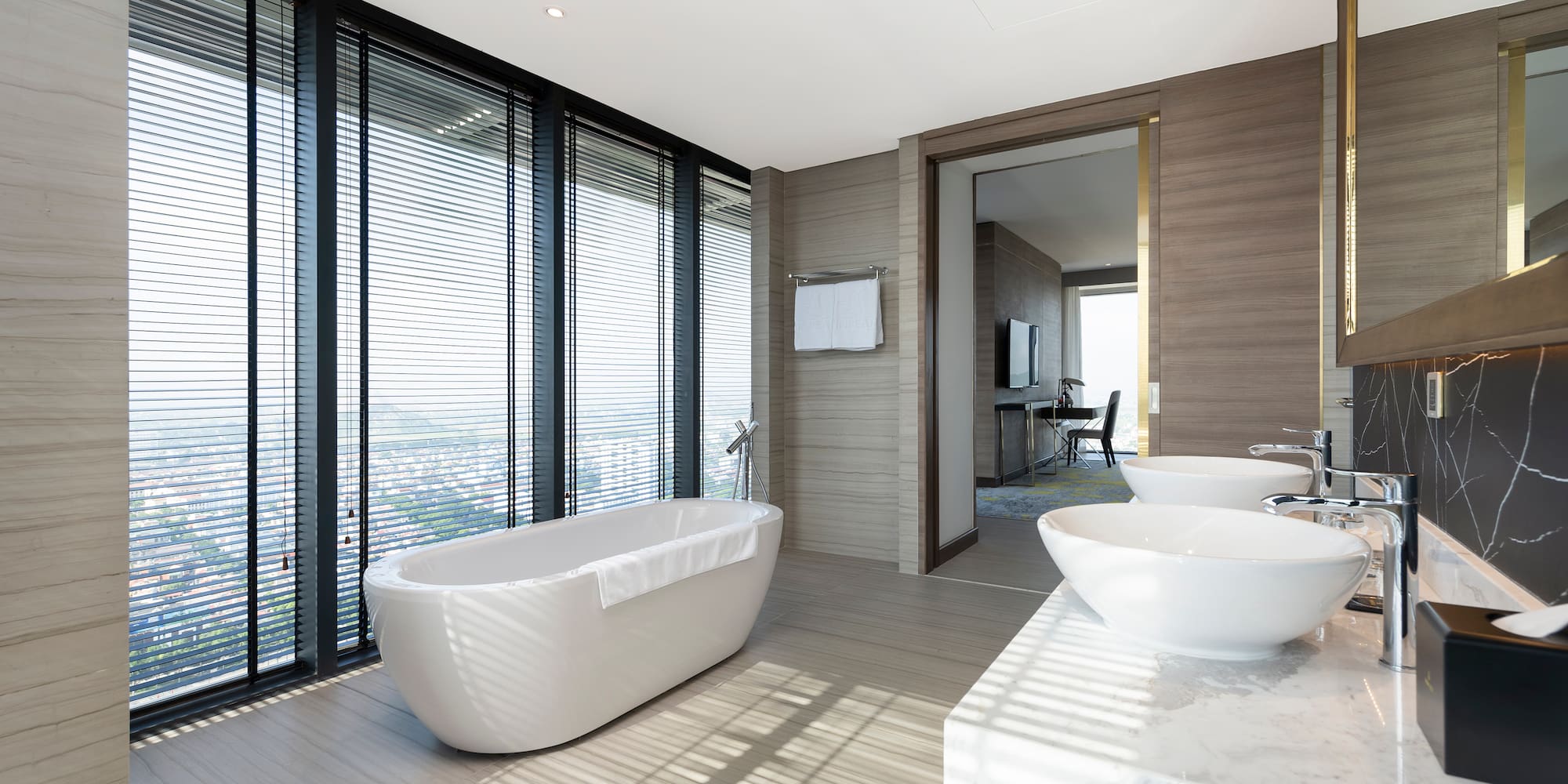 a bathroom with a tub and sinks