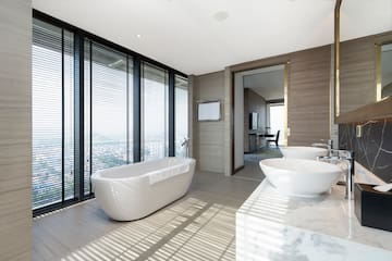 a bathroom with a tub and sinks