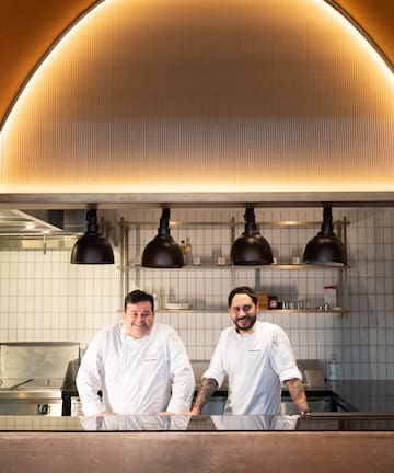 two men standing in a kitchen