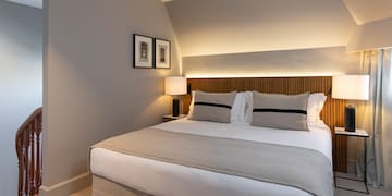 a bed with a lamp on the side