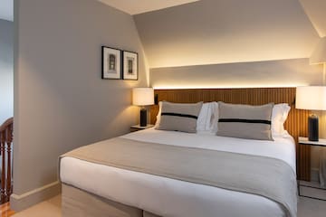 a bed with a lamp on the side