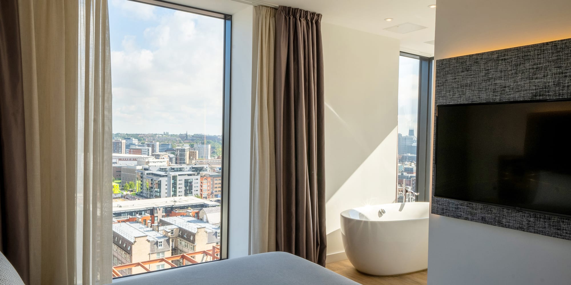 a room with a large window and a bathtub