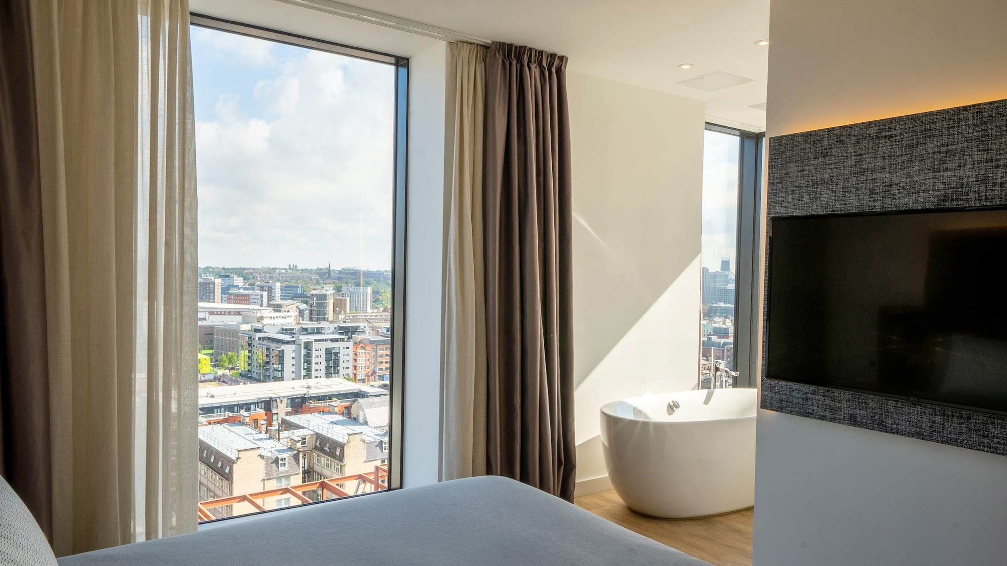 a room with a large window and a bathtub