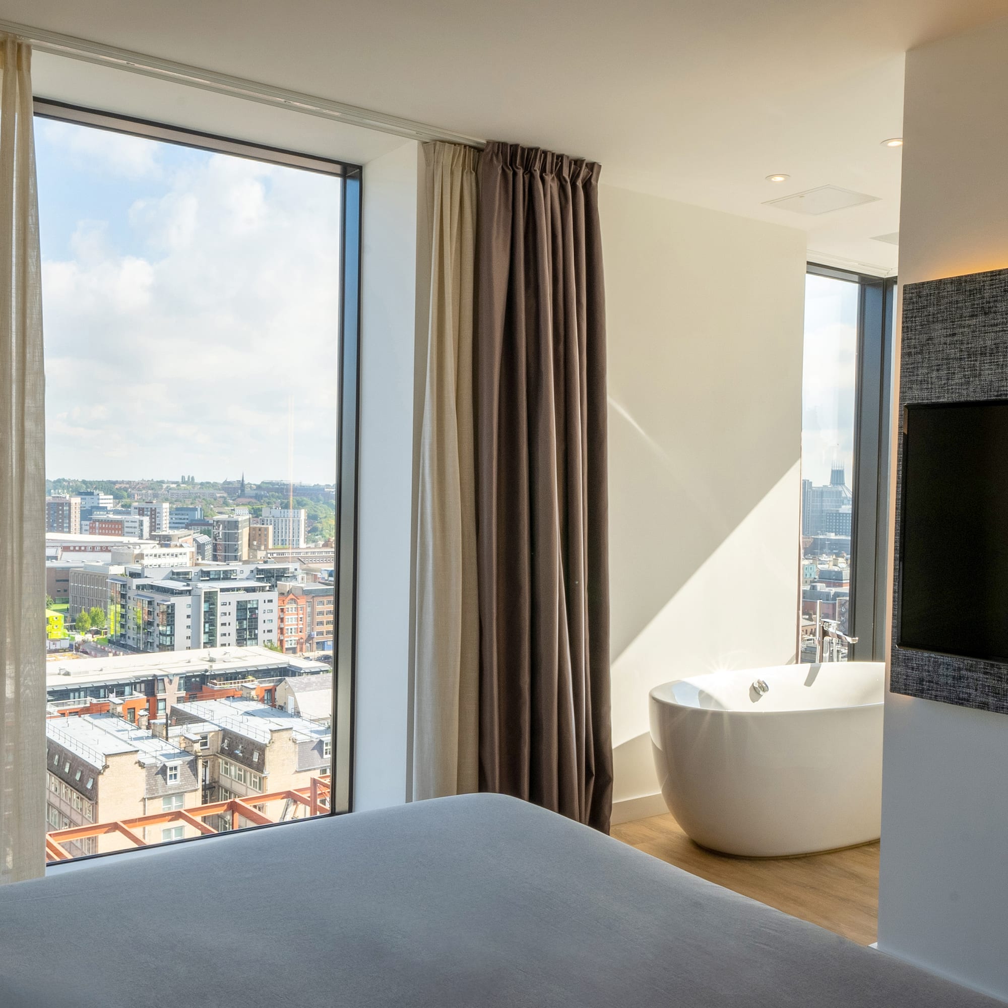 a room with a large window and a bathtub