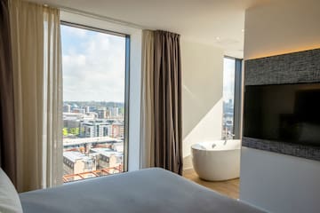 a room with a large window and a bathtub