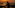 DJ performing a sunset set overlooking a beach and ocean.