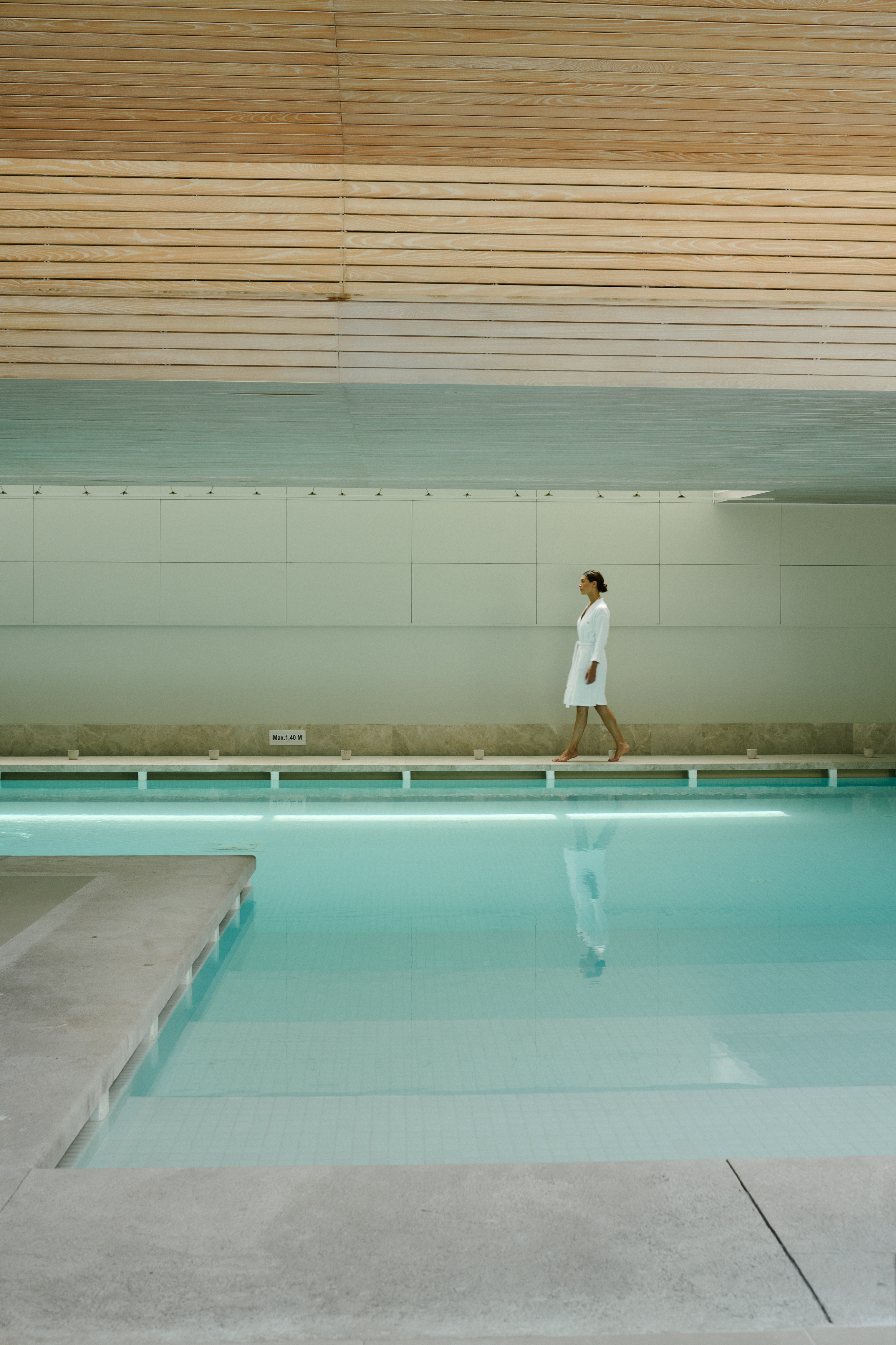 a woman walking near a pool