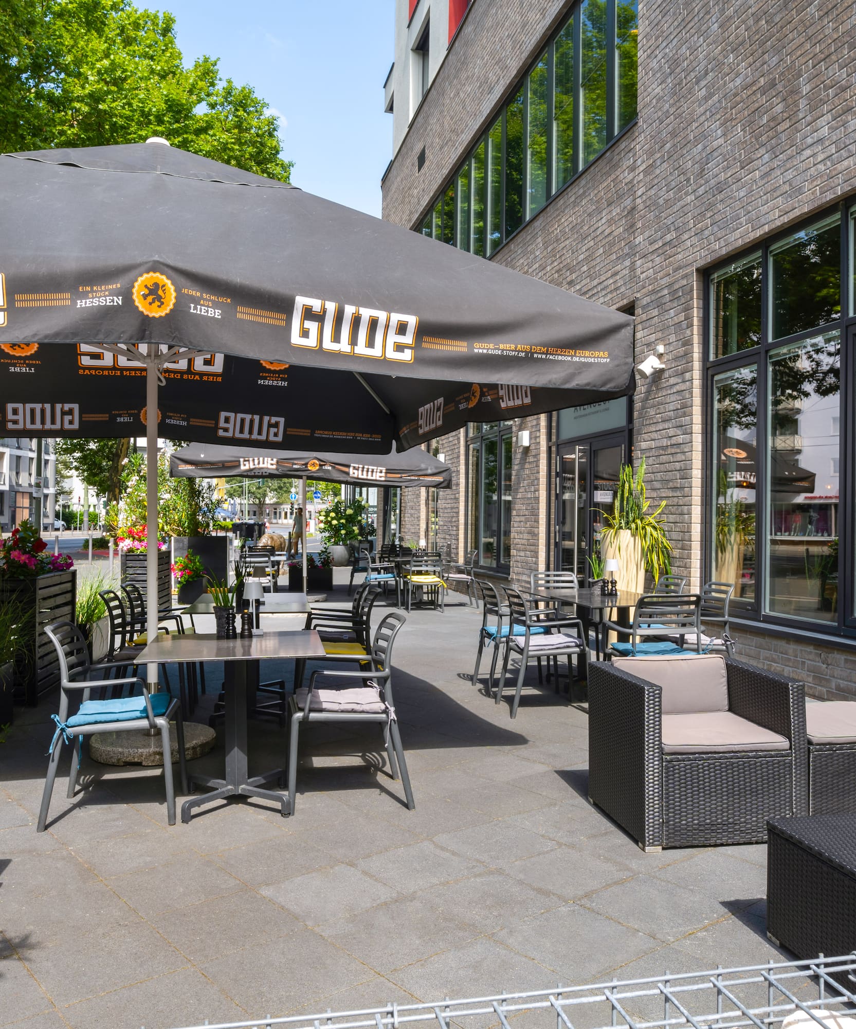 a patio with chairs and umbrellas
