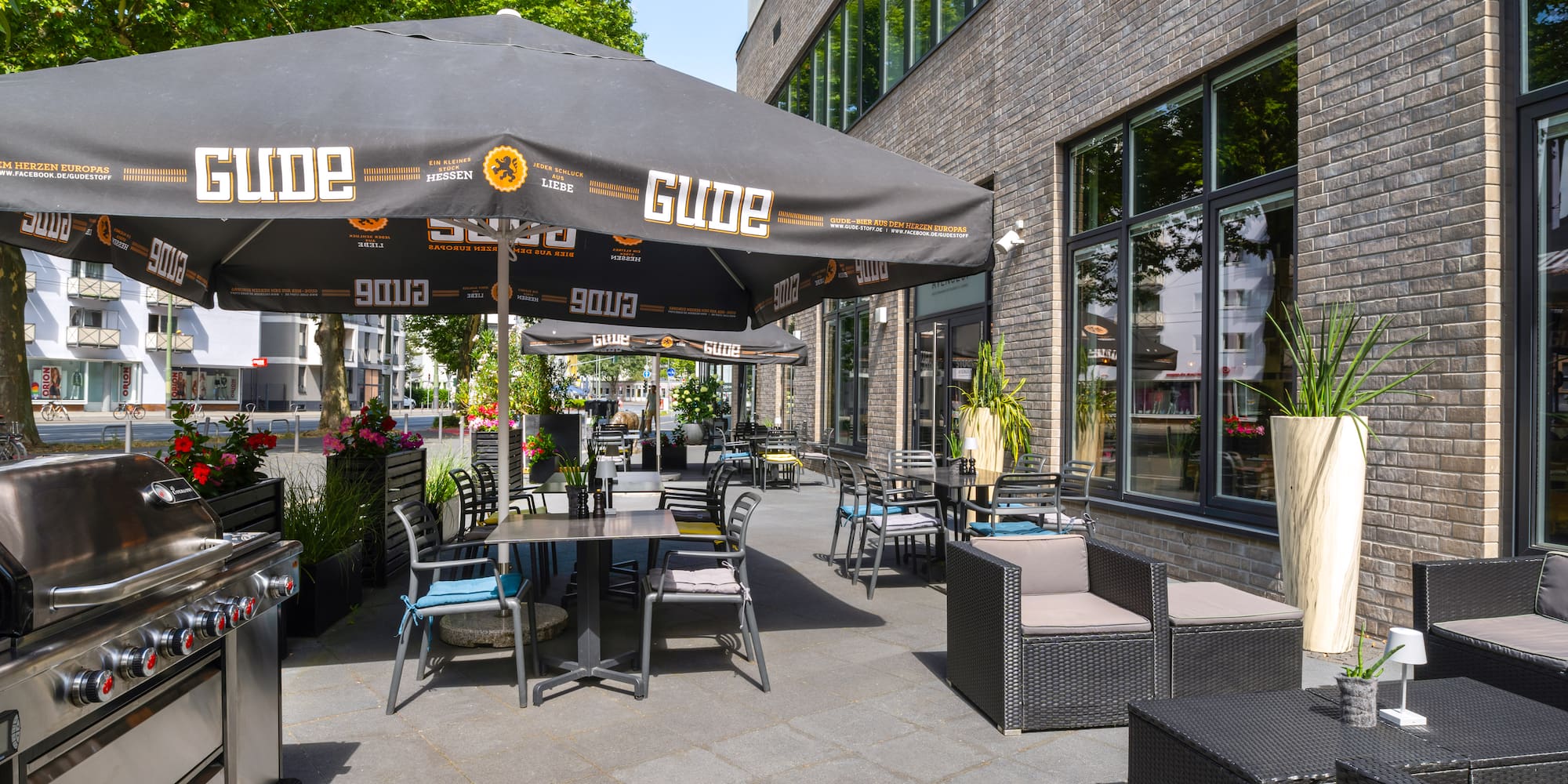 a patio with chairs and umbrellas