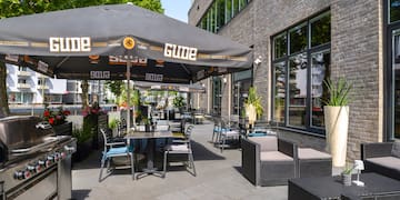 a patio with chairs and umbrellas