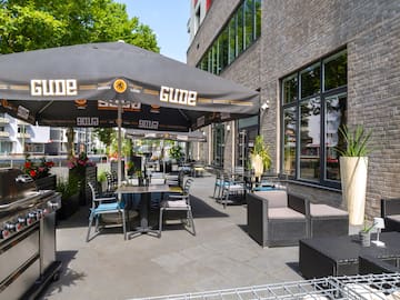 a patio with chairs and umbrellas
