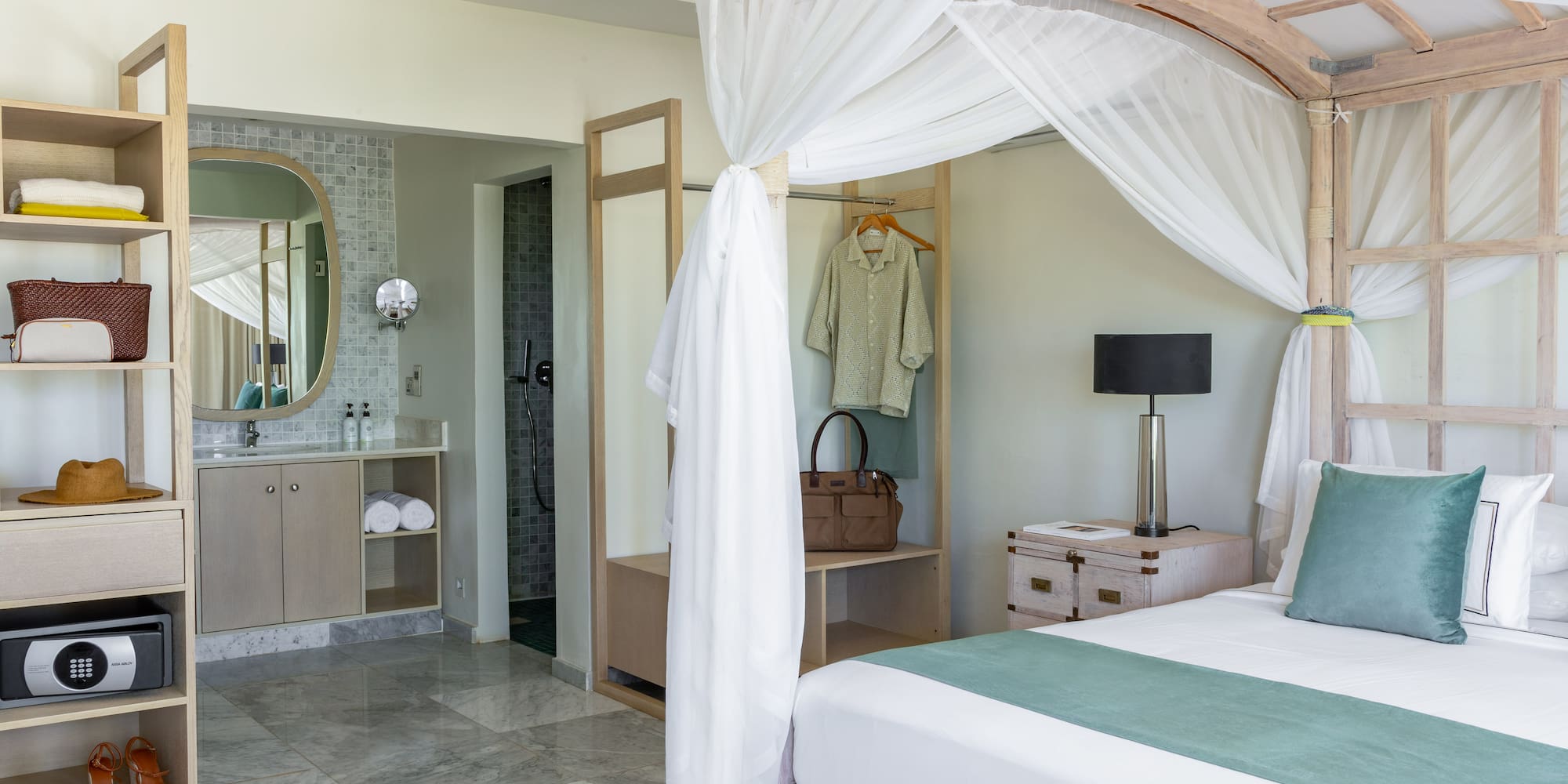 a bedroom with a canopy bed and a mirror