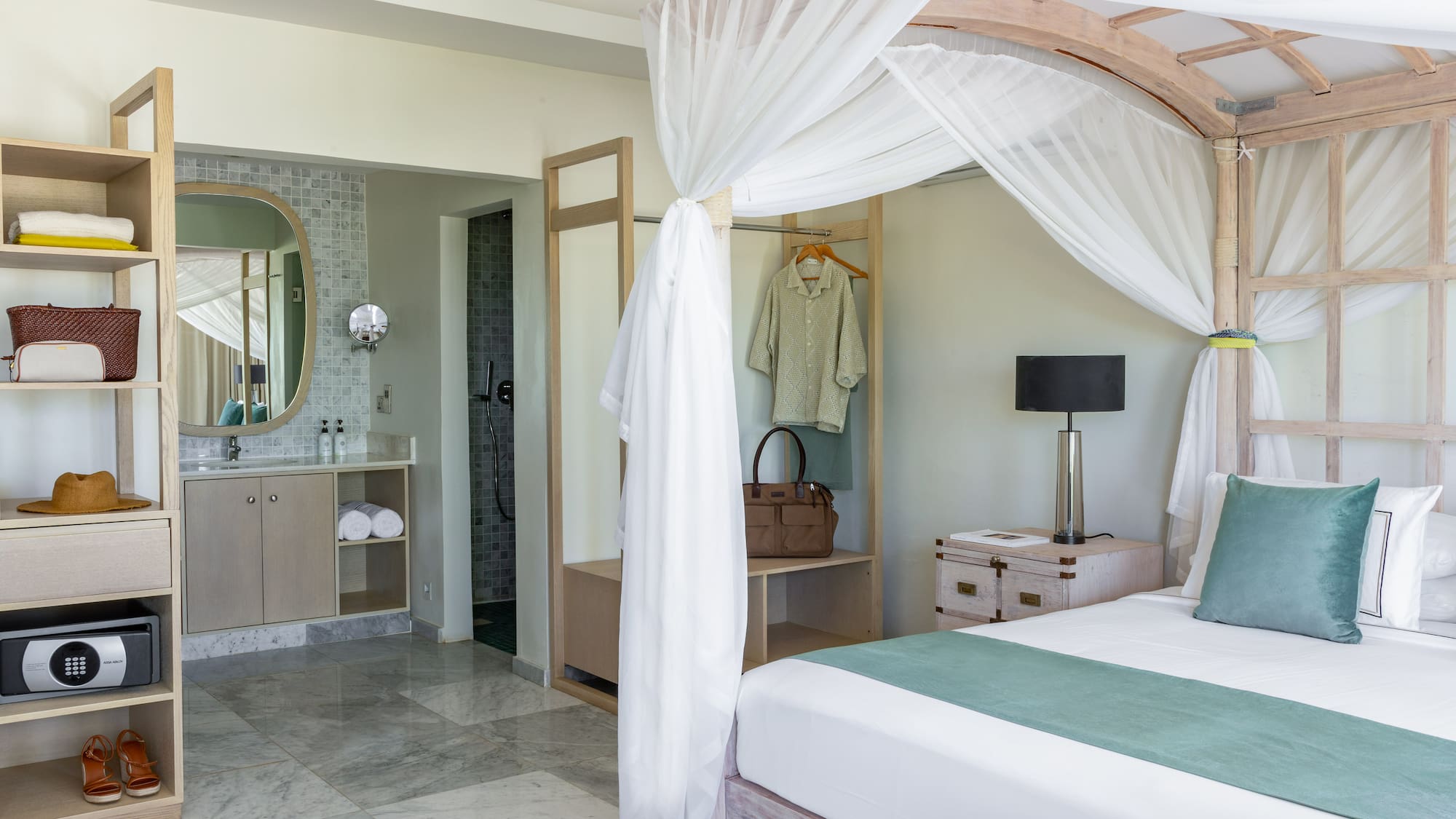 a bedroom with a canopy bed and a mirror