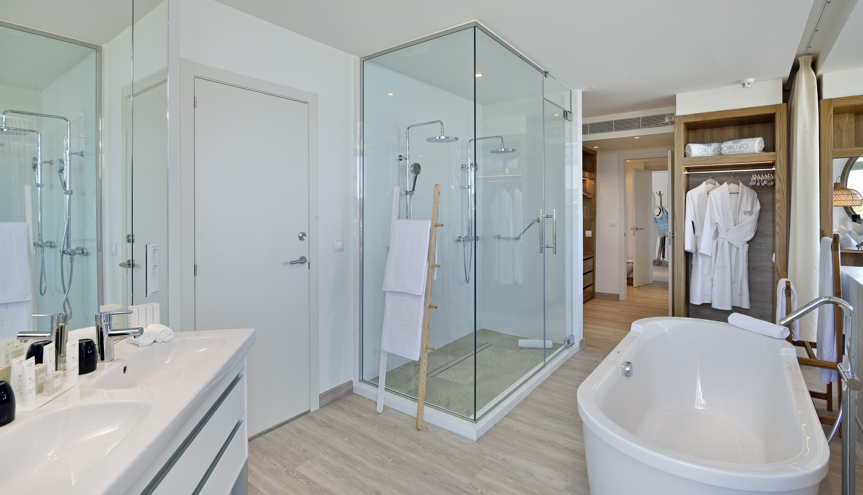 Modern bathroom with walk-in shower, freestanding tub, and double vanity.