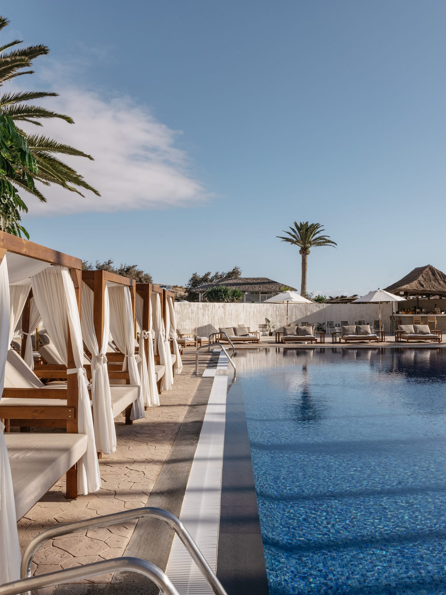 a pool with lounge chairs and umbrellas