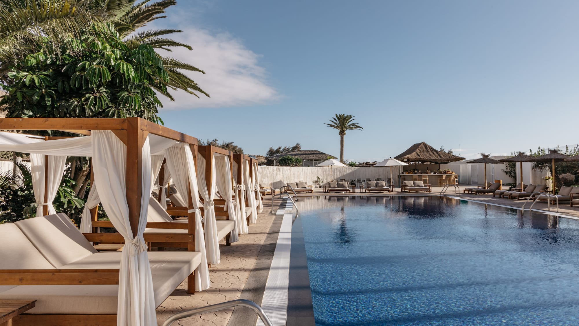 a pool with lounge chairs and umbrellas