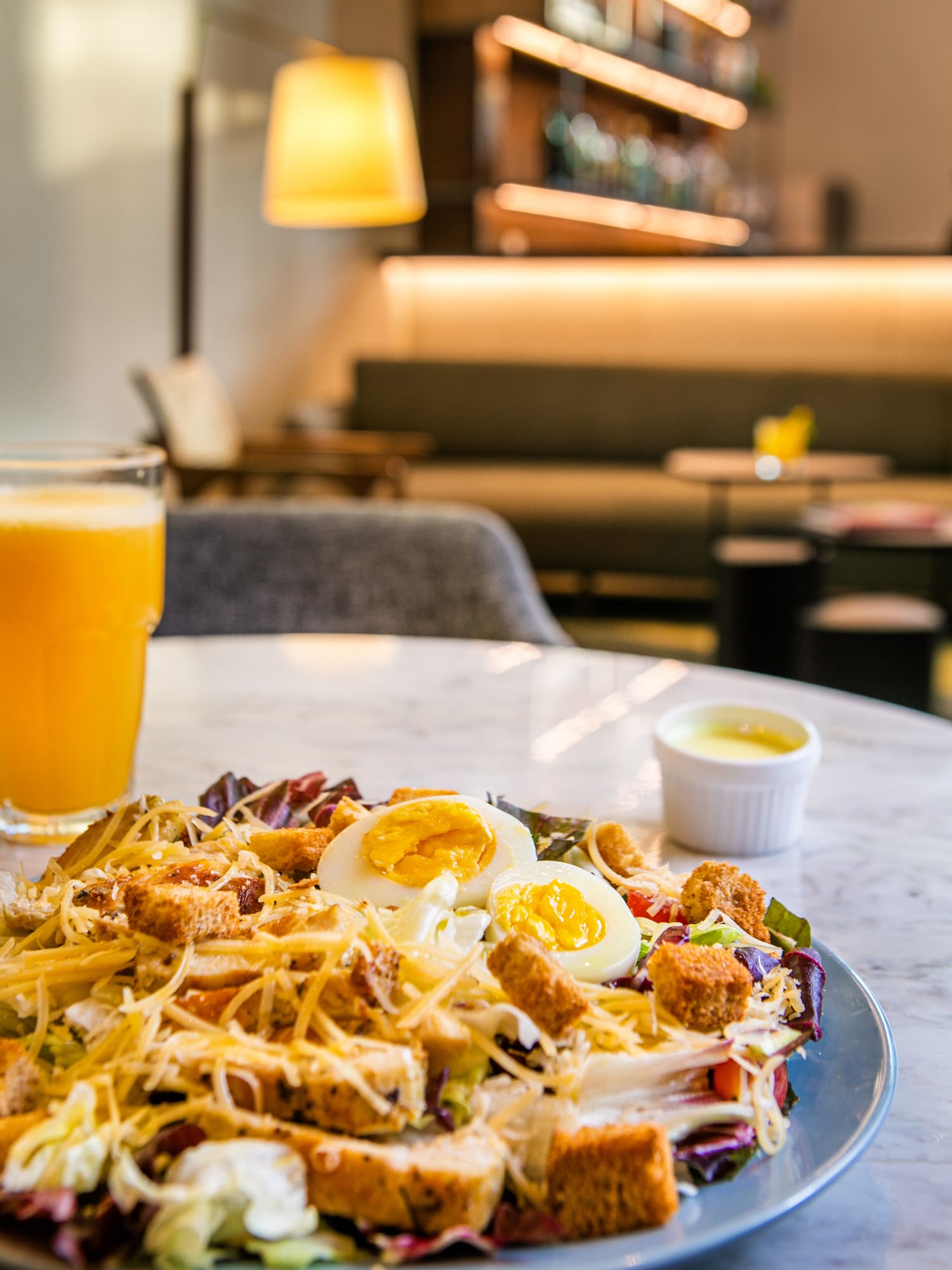 a plate of salad with eggs and cheese on a table