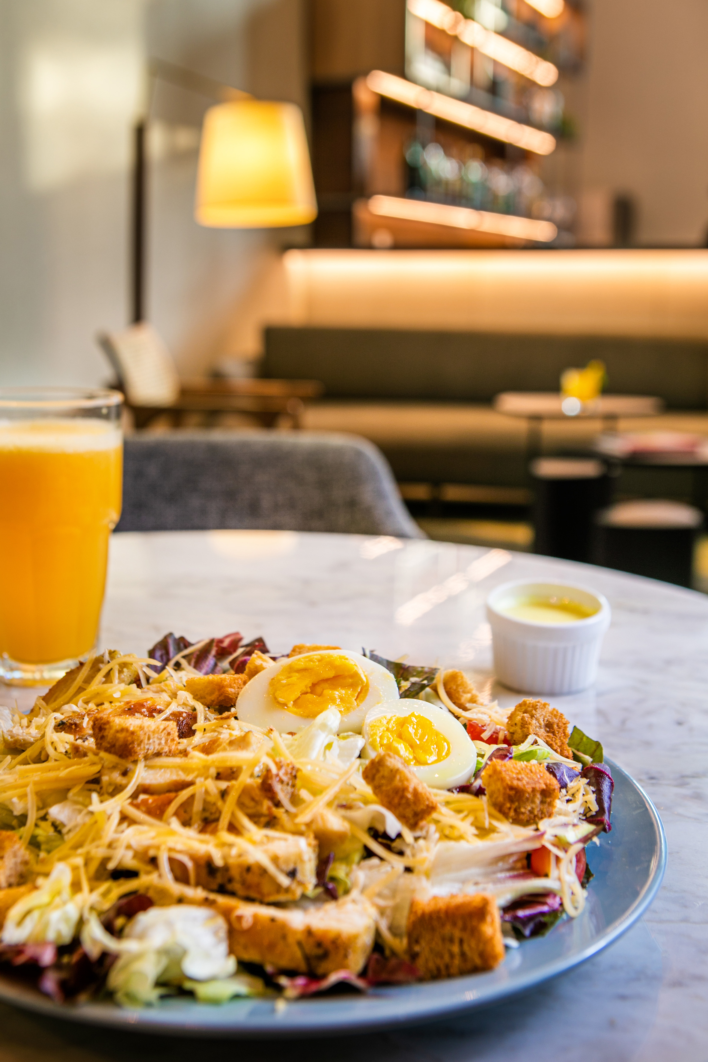 a plate of salad with eggs and cheese on a table