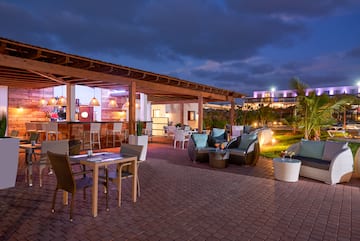 a patio with chairs and tables