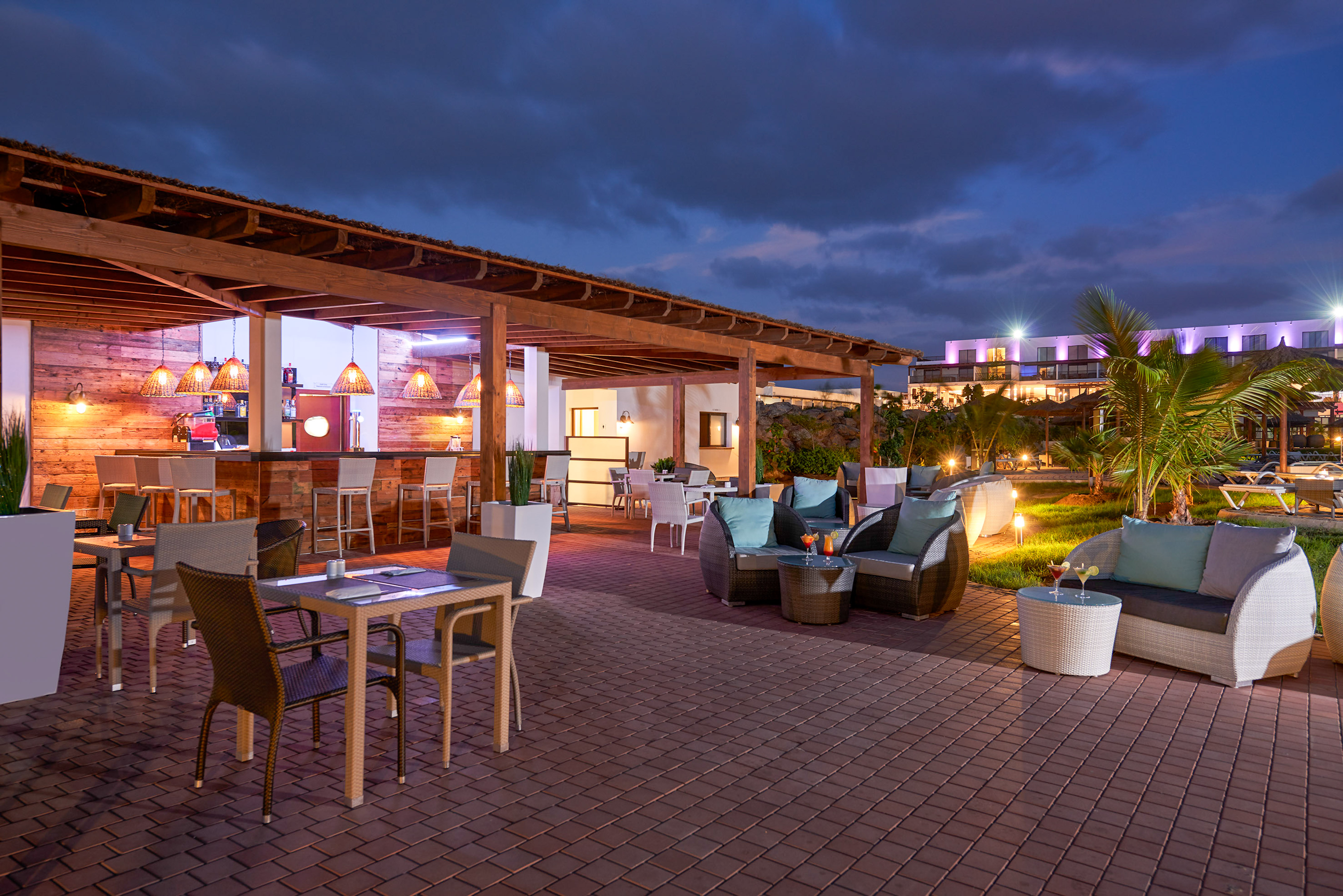a patio with chairs and tables