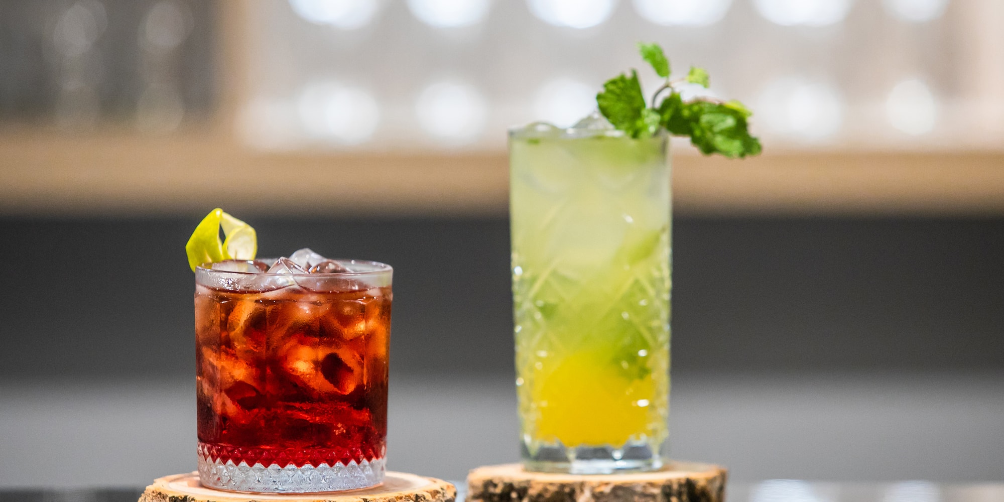 two glasses of drinks on a table